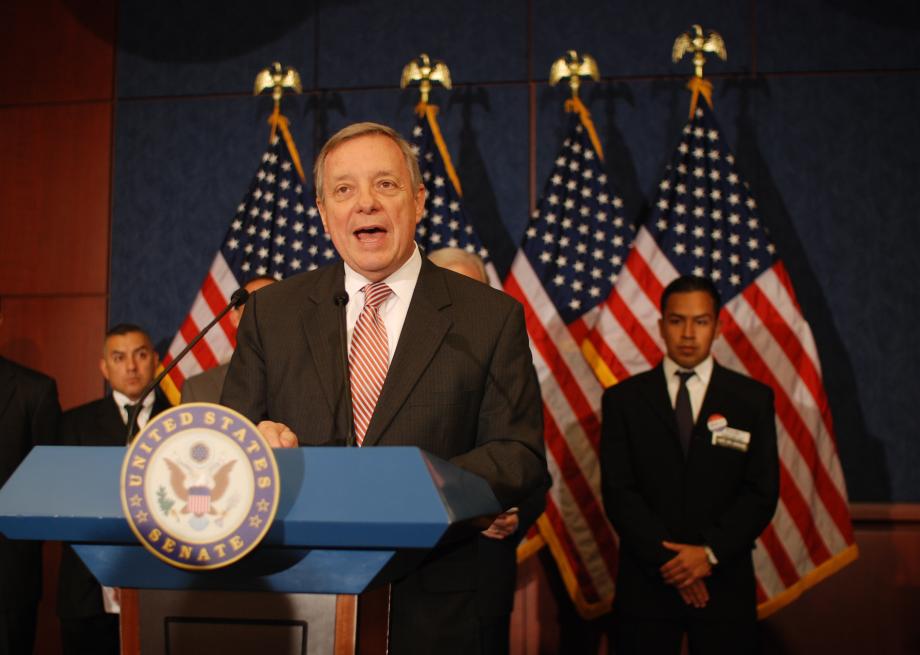 Durbin speaks to the press about his DREAM Act, a bill that would give a select group of undocumented students a chance to earn legal status provided they came here as children, are long-term U.S. residents, have good moral character, and complete two years of college or military service in good standing. Cesar Vargas, a law student who could enlist in the military under the bill watches.